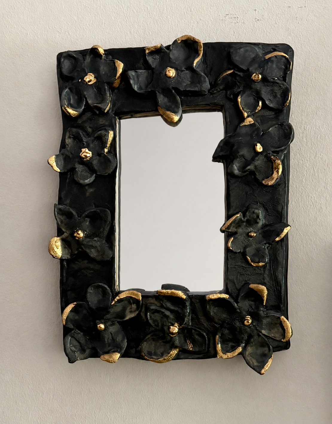 One-of-a-kind petite ceramic wall mirror with gold tipped flowers