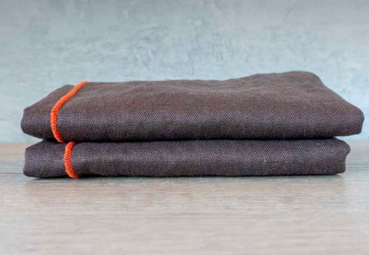Brown linen napkins with orange embroidered trim